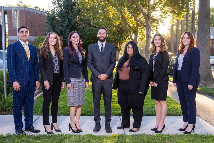 A group photo of 7 students in suits